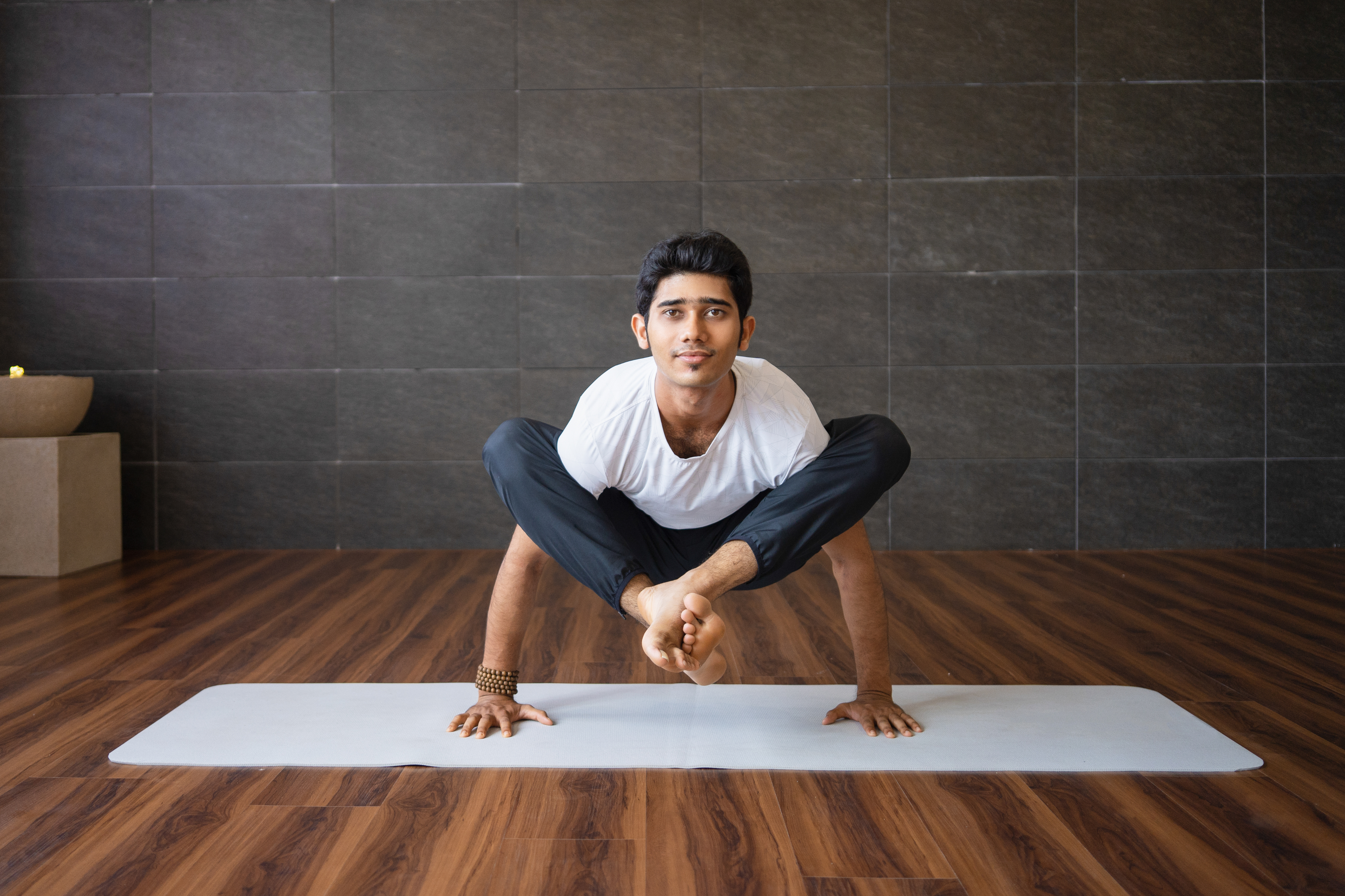 Yoga practitioner in an advanced arm balance pose